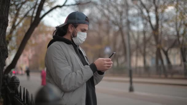 Young Handsome Man Antiviral Mask Man Holds Phone His Hands — Vídeo de stock