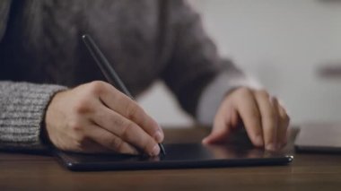  Serbest çalışan sanatçı bir grafik tableti çizer.