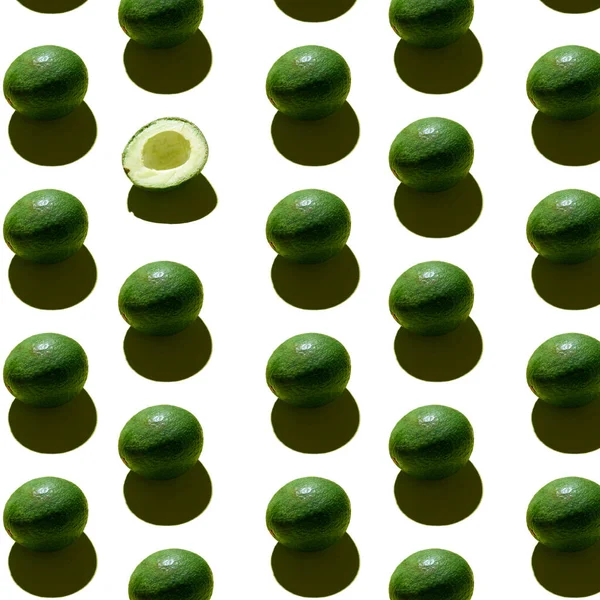 Beyaz arka planda avokado deseni. Üst Manzara. Yaratıcı yaz yemekleri konsepti. Yeşil avokadolar, en az düz yatış tarzı..