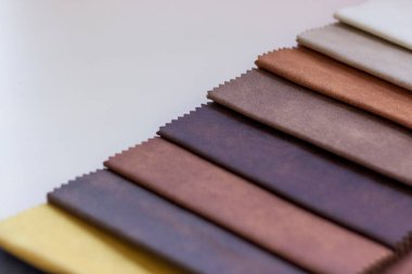 Bej bir arka planda tekstil, mobilya ve giysi dekorasyonu için doğal ve yapay kumaşlardan yapılmış arka planlar. Mobilya üretimi. Metni kopyalamak için alanı olan duvar kağıdı. Doku