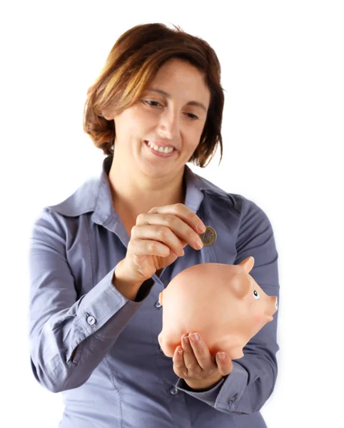 Woman puts the money in his piggy bank — Stock Photo, Image