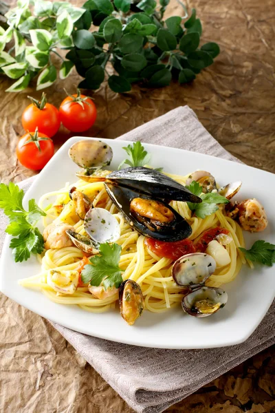 stock image Spaghetti with salmon, clams and mussels