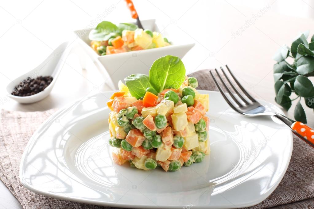 Russian salad with peas, carrots, potatoes and mayonnaise