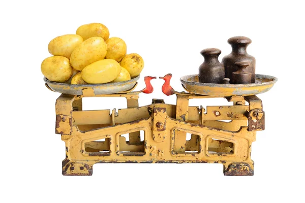 Potatoes on old scales — Stock Photo, Image