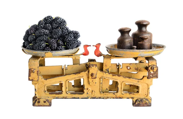 Black mulberry on old scales — Stock Photo, Image