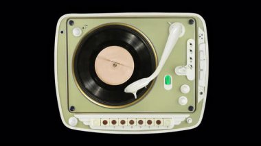 Turuncu etiketli eski siyah plak dönüyor ve fildişi tonkollu, kumandalı ve yeşil tüp seviyesinde kedi gözlü yeşil portatif bir pikapta çalıyor. Şeffaf alfa kanalı ve alfa matte ile döngü hareketi