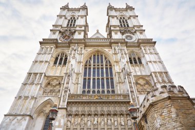Westminster Abbey church facade on cloudy sky in London