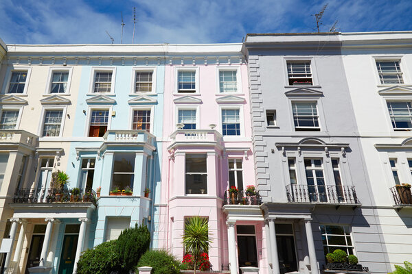 Colorful English houses facades in London, blue sky in a sunny day