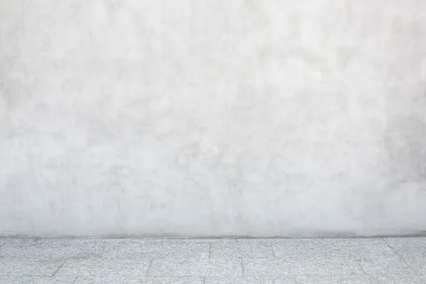 Gray cement wall with empty stone tiled floor — Stock Photo, Image