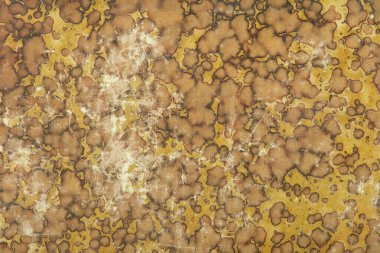 Sarı ve kahverengi solmuş soyut desen arkaplanı olan eski karton.