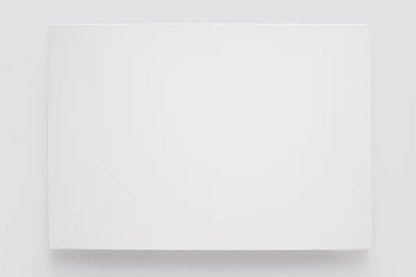 White canvas on stretcher on white wall — Stock Photo, Image