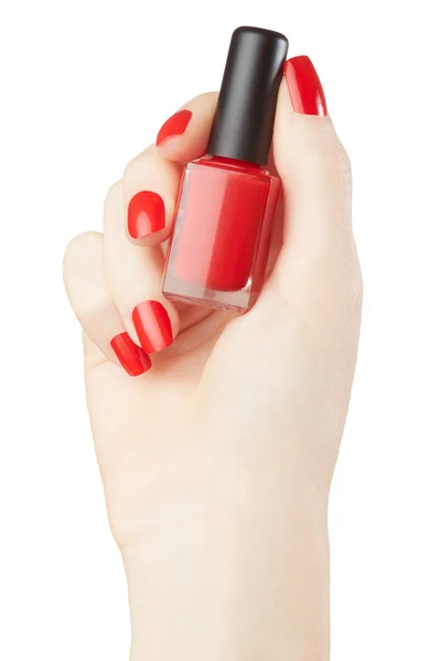 Woman hand manicure with red nail polish bottle — Stock Photo, Image