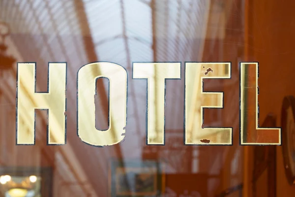 Hotel old sign on glass — Stock Photo, Image