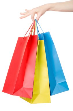 Woman hand holding colorful shopping bags on white
