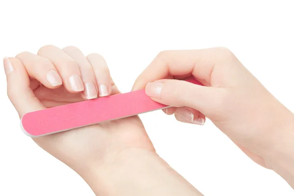 Woman hands manicure with nail file on white — Stockfoto