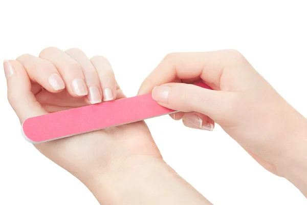 Woman hands manicure with nail file on white — Stock Photo, Image