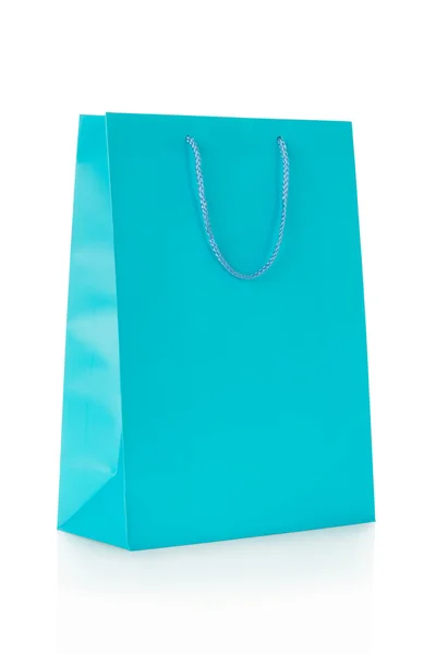 Blå shopping väska i papper på vit Stockbild