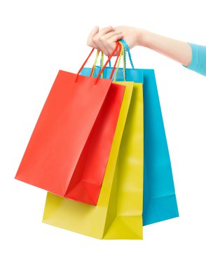Woman hand holding shopping bags on white