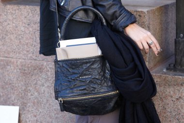 Woman poses for photographers with Givenchy bag, Milan fashion week