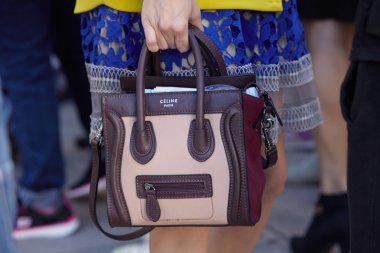 Woman poses for photographers with Celine bag, Milan fashion week