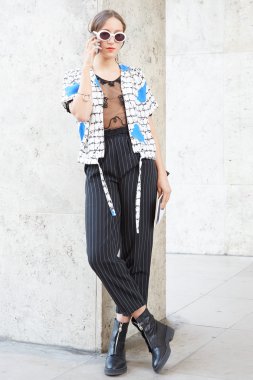 Woman poses for photographers before Rochas show, P