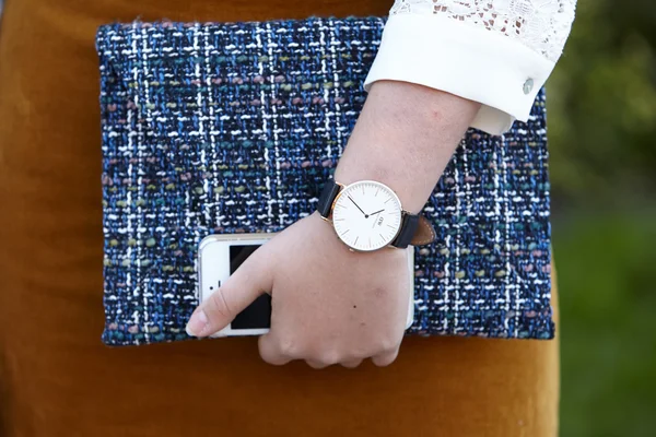 Woman poses for photographers with Daniel Wellington watch, Paris fashion week — стокове фото