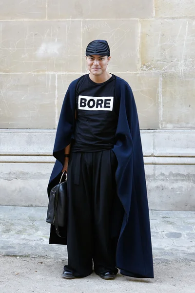 Man poses for photographers before Yang Li show, Paris fashion week