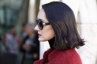 Woman poses for photographers with Bulgari sunglasses, Milan fashion week