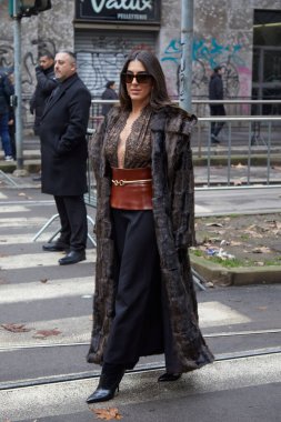 MILAN, ITALY - JANUARY 17, 2026: Nil Ninat with long, dark fur coat and black skirt before Dolce and Gabbana fashion show, Milan Fashion Week street style