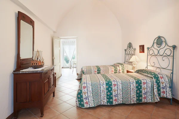 Old bedroom with two beds in ancient house