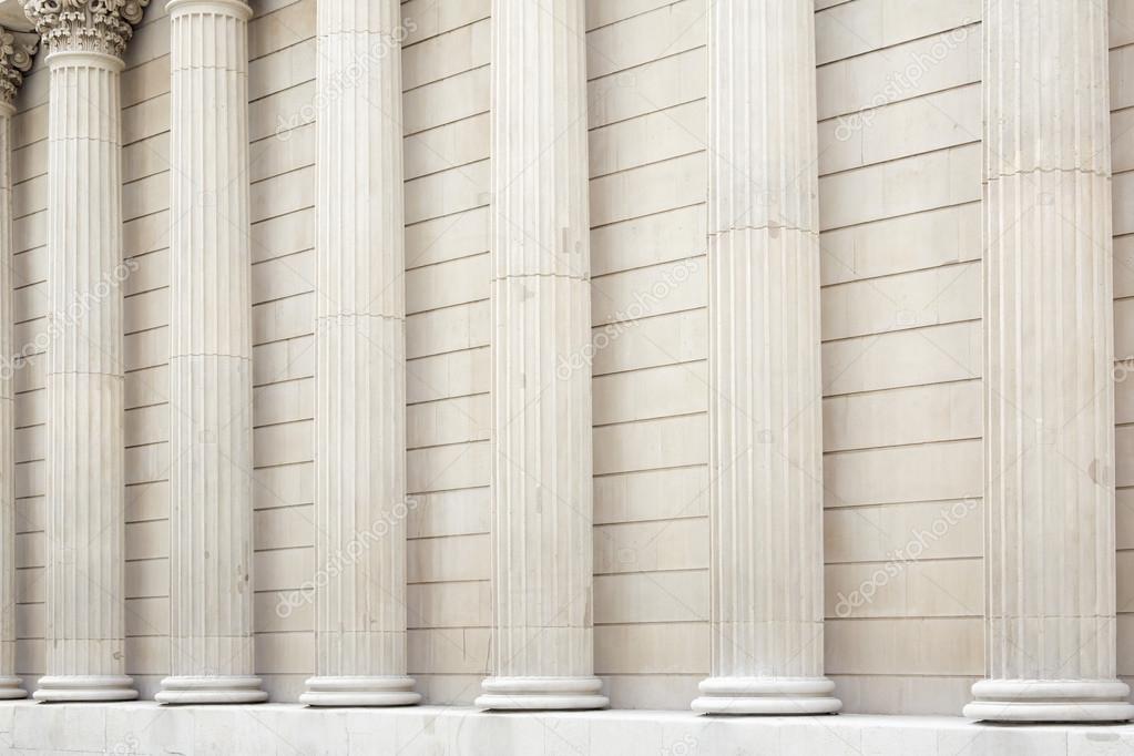 White classical columns and wall background