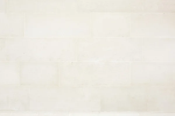 ベージュのタイル張りの石造りの壁のテクスチャ背景 — ストック写真
