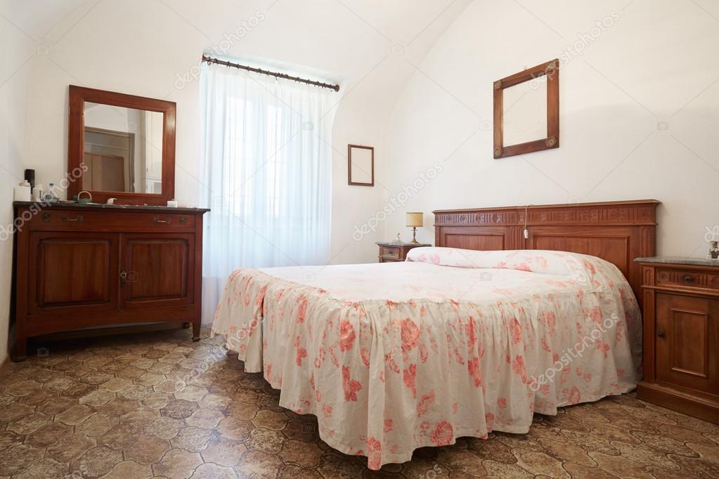 Old bedroom with queen size bed in ancient house
