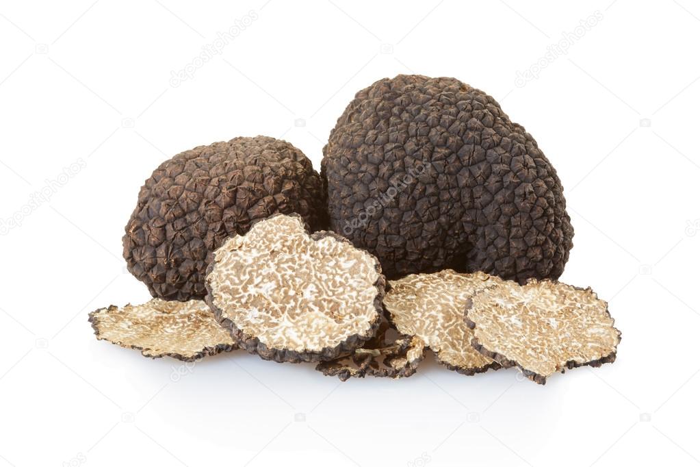 Black truffles group and slices isolated on white