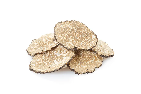 Black truffle slices heap on white — Stock fotografie