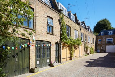 Bricks mews houses in London in a sunny day, England clipart