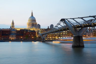 St Paul's cathedral and Millennium bridge in London in a clear evening