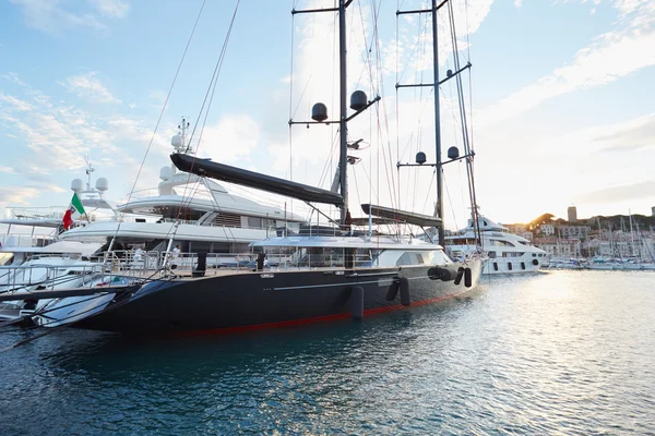 Modern black an red luxury sail boat in Cannes harbor