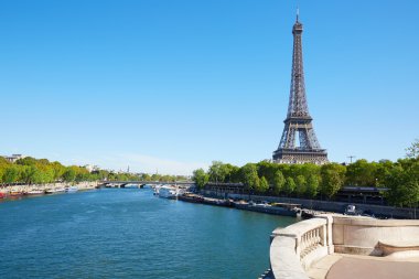 Eiffel tower and empty white balustrade on Seine river in a sunny day