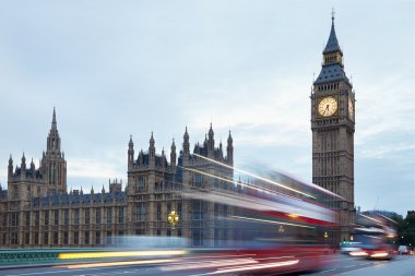 Big Ben and Palace of Westminster in the early morning, red buses in London