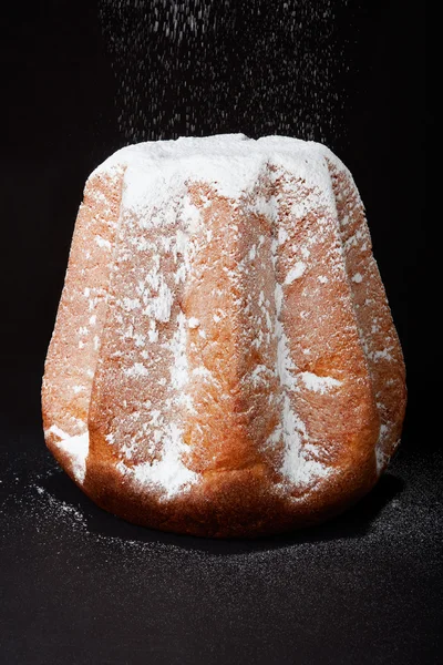 Pandoro, Christmas cake with icing sugar snow on black — Stock Photo, Image