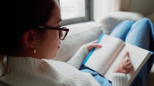 Young Woman Reading Book Sofa — Stock Video