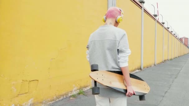 Mladá Žena Sluchátky Skateboard Chůze Podél Zdi — Stock video