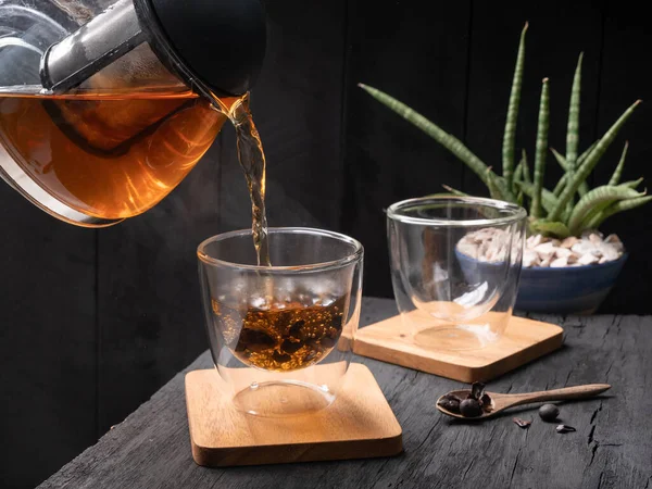 Pouring Steam Cascara Tea Kettle Glass Tea Cup Dark Wood — Stock Photo, Image