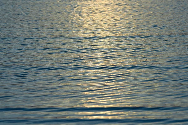 Ripple wave texture at golden sunrise background — Stock Photo, Image