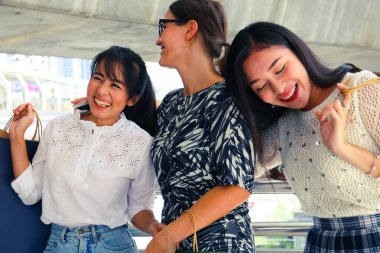 Güzel üç kadın gülümseme ve siyah Cuma alışveriş için mutlu.