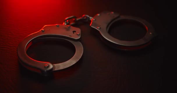 Pair Handcuffs Used Law Enforcement Arrest Criminals Lit Red Blue — Stock Video