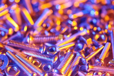 Nuts and bolts background in bright colorful lights
