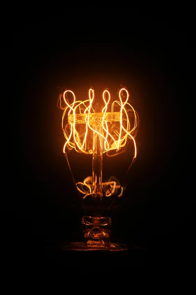 Vintage light bulb glowing — Stok fotoğraf