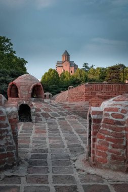sulfur baths Abanotubani area in the city of Tbilisi in Georgia overlooking the Metekhi Temple - a church in the name of the Assumption of the Blessed Virgin Mary